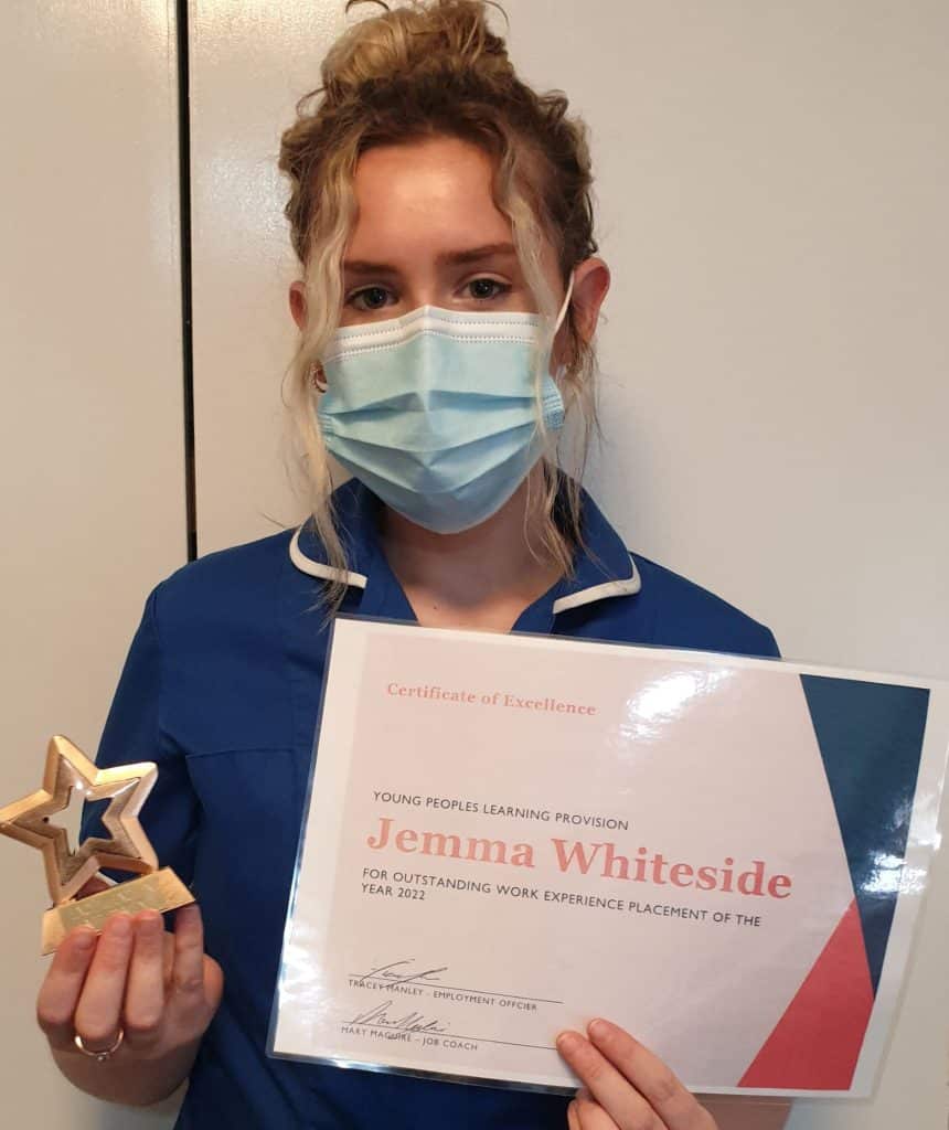 Jemma Whiteside receiving her work placement trophy and certificate